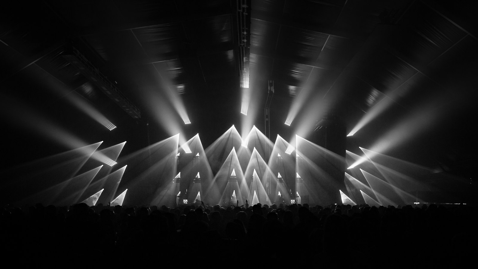 Stage lit by dramatic beams of light before a live show